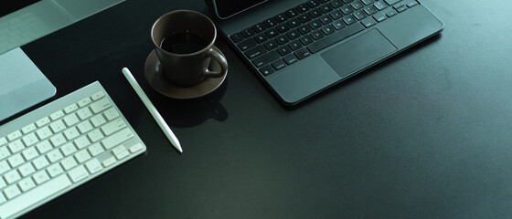 Office desk with computer keyboard, laptop keyboard, coffee cup and copy space