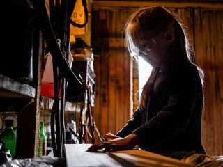 Portrait of a little girl. Girl working in the garage