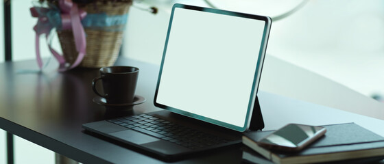 Portable workspace with digital tablet and supplies on the table, include clipping path