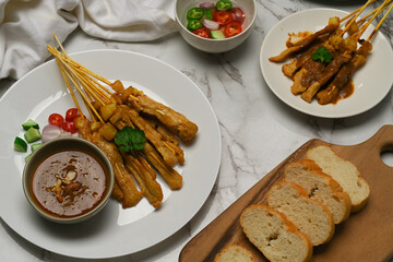 Grilled pork satay (Moo Satay) served with peanut sauce and grilled bread