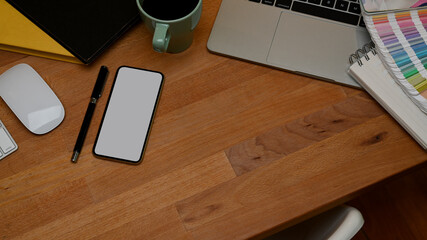 Wooden table with smartphone, laptop, supplies and copy space, include clipping path