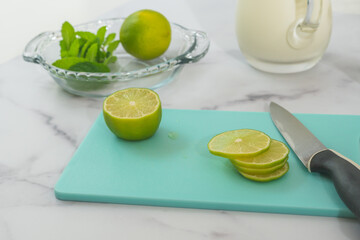 Lemon slices close up on cutting board on marble kitchen table