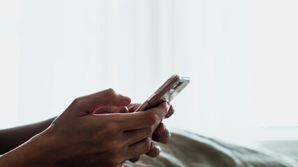 Woman texting in her bed