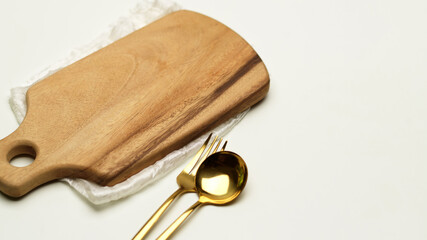 Dinning table with wooden tray, cutlery, napkin and copy space in restaurant