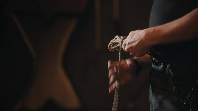 BDSM concept - imperious man holds ropes