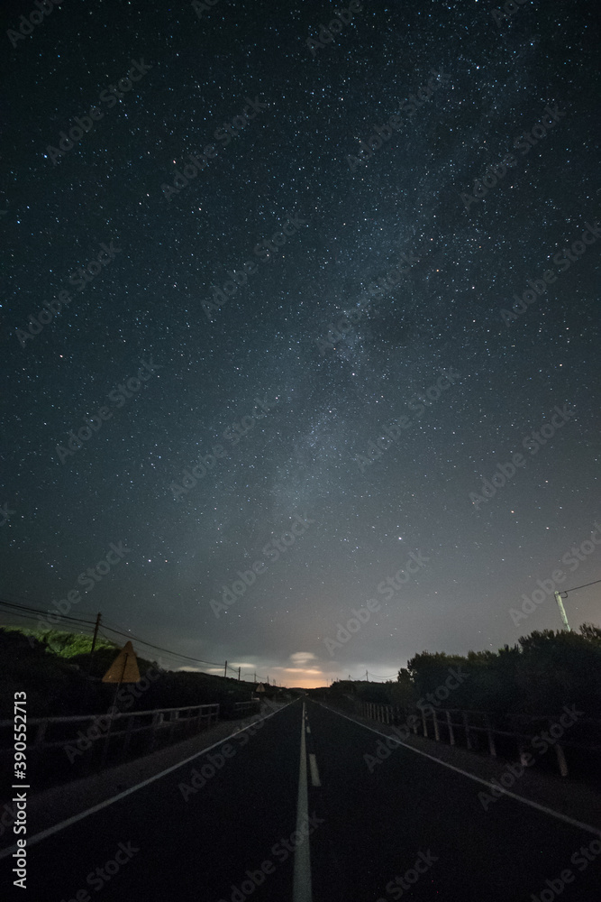 Wall mural Night landscape with deserted road and starry sky.