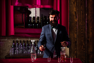 Portrait of cheerful barman worker standing. Attractive bar man in whiskey bar.