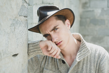 Stylish young man against a grey wall.