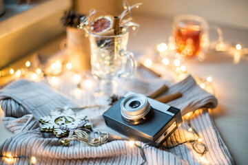 Flat lay composition with camera, Christmas decor on wooden background, travel for Chrismas vacation concept.