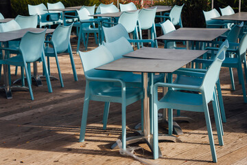 Fototapeta na wymiar Des chaises et des tables de restaurant vides à cause du confinement. Une absence de clients. Un restaurant sans client.