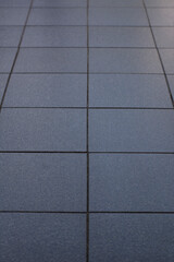 Perspective view of blue floor tiles pattern background.