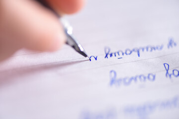 Closeup of hand writing in cyrilic with fountain pen