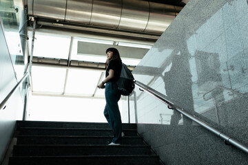 Fototapeta na wymiar Woman walking on stair from underground metro.