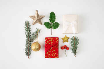 top view of Christmas decoration on white background. Pine fir, gift box, bauble, star.