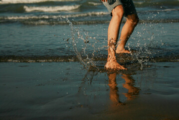close up person playing with his foot on the beach