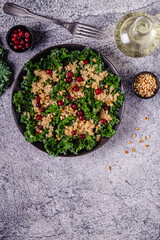Healthy raw kale and quinoa salad with cranberry and pine nut.