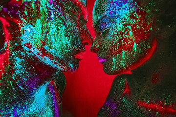 People are colored fluorescent powder. a pair of lovers dancing at a disco.