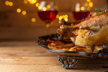 Dish with traditional baked turkey on glasses with wine background. Concept of festive dinner. Thanksgiving day.