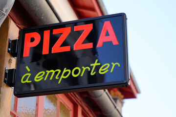 Pizza restaurant sign outside in france a emporter means to take away