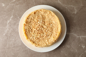 Plate with delicious Napoleon cake on gray table