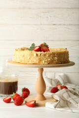 Concept of tasty lunch with stand with Napoleon cake with strawberry