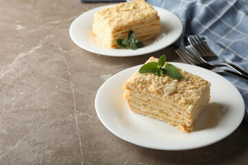 Concept of tasty lunch with Napoleon cake on gray table