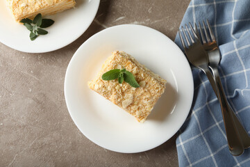 Concept of tasty lunch with Napoleon cake on gray table