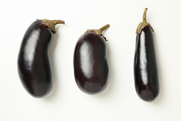 Fresh raw eggplants on white background, top view