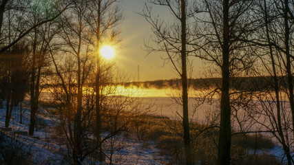 frosty winter over the river, sunset