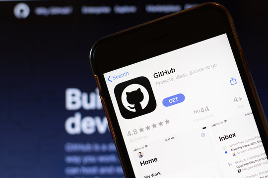 Los Angeles, California, USA - 24 March 2020: GitHub app logo on phone screen close up with website on background with icon, Illustrative Editorial