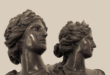 Fototapeta na wymiar Gypsum copy of ancient statue heads on dark textured background. Plaster sculpture face