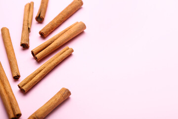 Cinnamon sticks on color background