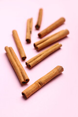 Cinnamon sticks on color background