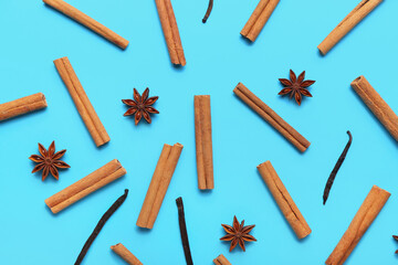 Cinnamon sticks, vanilla and anise on color background