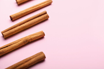 Cinnamon sticks on color background