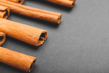 Cinnamon sticks on grey background, closeup