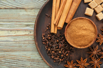 Composition with cinnamon and spices on wooden background
