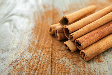 Cinnamon sticks on wooden background, closeup
