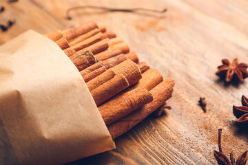 Cinnamon sticks on wooden background, closeup