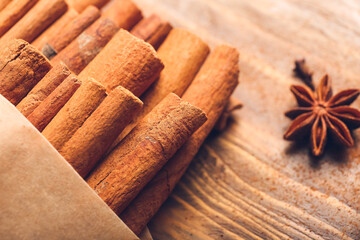 Cinnamon sticks on wooden background, closeup