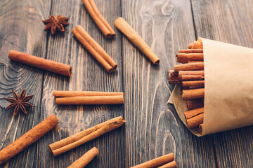 Cinnamon sticks and anise on wooden background