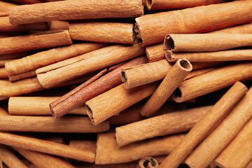 Many cinnamon sticks as background
