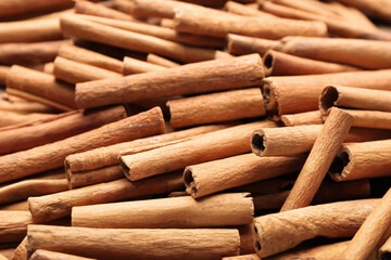 Many cinnamon sticks as background
