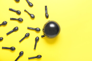 Composition with black balloons on color background