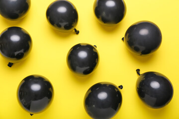 Black balloons on color background