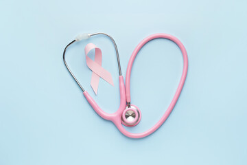 Pink ribbon and stethoscope on color background. Breast cancer awareness concept