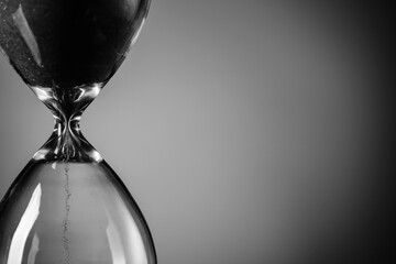 Hourglass on grey background, closeup. Time management concept