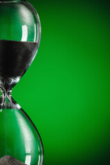 Hourglass on color background, closeup. Time management concept