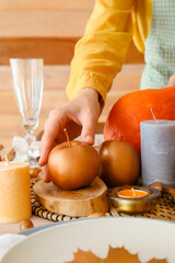 Woman serving table for Thanksgiving Day celebration at home
