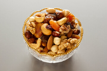 Mixed nuts in a glass plate. Healthy and natural nutrition .Cashew, Almond,, Hazelnut,, Fig,, Walnut,, Apricot,, Raisin,, Blueberry.